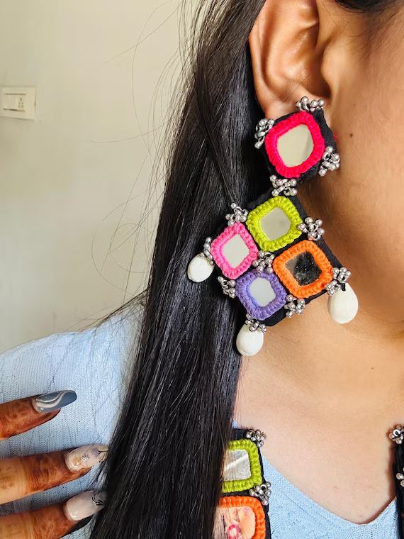 Colourful mirror-work earrings worn